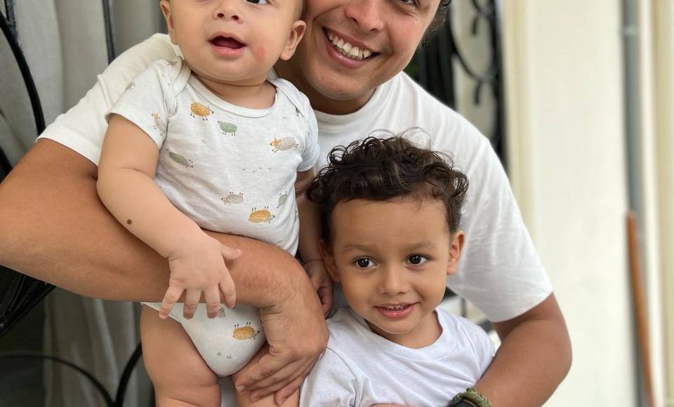 Onel Pineda, animador y productor visual en radio XY, posa con su hijo Onel y su hijastro Gianlucas. 