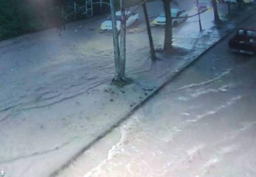 In this Monday, Feb. 10, 2020, photo, a student at the University of Alabama makes her way through the downpour in Tuscaloosa, Ala. Roads are flooding and rivers are rising across the Deep South after a day of heavy rains. The National Weather Service says minor to moderate flooding is expected from central Mississippi to north Georgia following downpours. (Gary Cosby Jr./The Tuscaloosa News via AP)