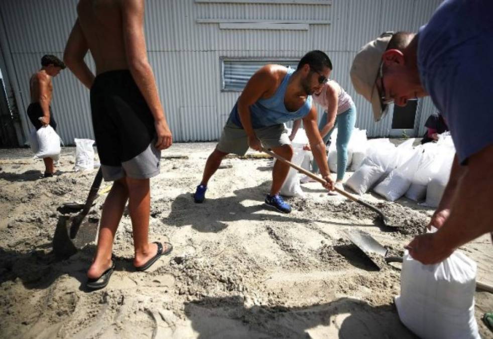 WRIGHTSVILLE BEACH, NC- SEPTEMBER 11: Local residents fill sand bags that was provided by the town as they prepare for the arrival of Hurricane Florence on September 11, 2018 in Wrightsville Beach, United States. Hurricane Florence is expected on Friday possibly as a category 4 storm along the Virginia, North Carolina and South Carolina coastline. Mark Wilson/Getty Images/AFP