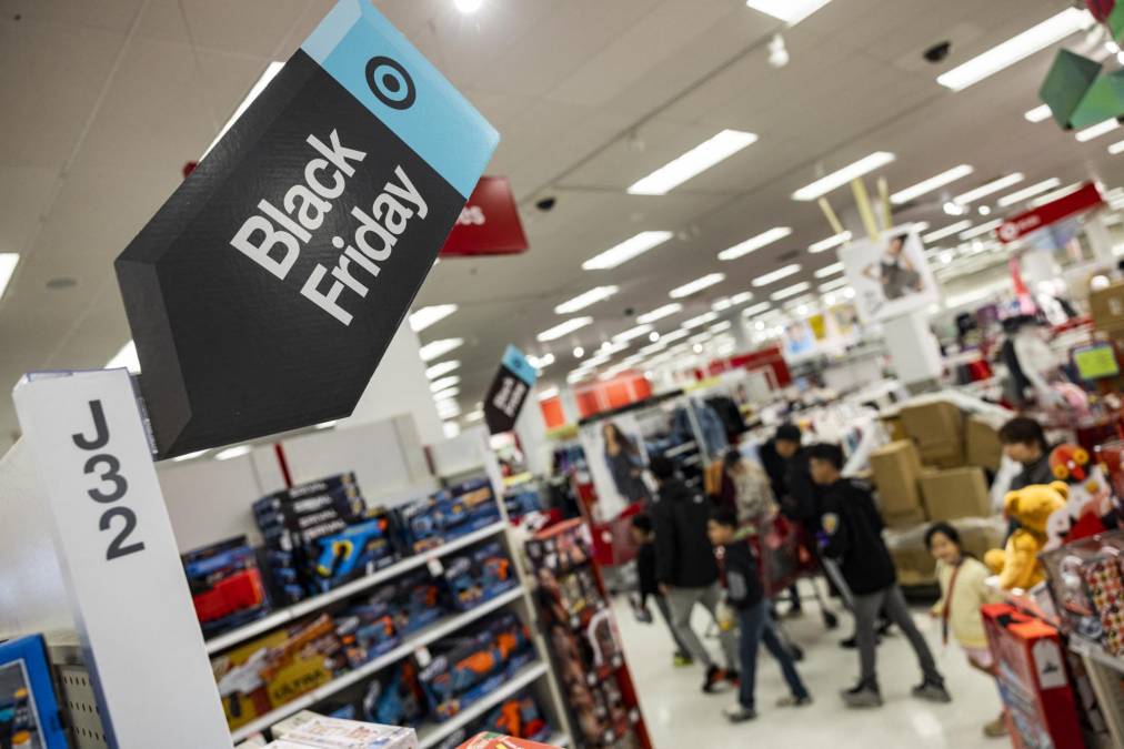 Black Friday sales signs are posted at a Target store in Rockville, Maryland, on November 25, 2022 . - With inflation on the rise, retailers are expecting that many shoppers will be looking for especially good deals as discretionary spending falls. (Photo by SAMUEL CORUM / AFP)
