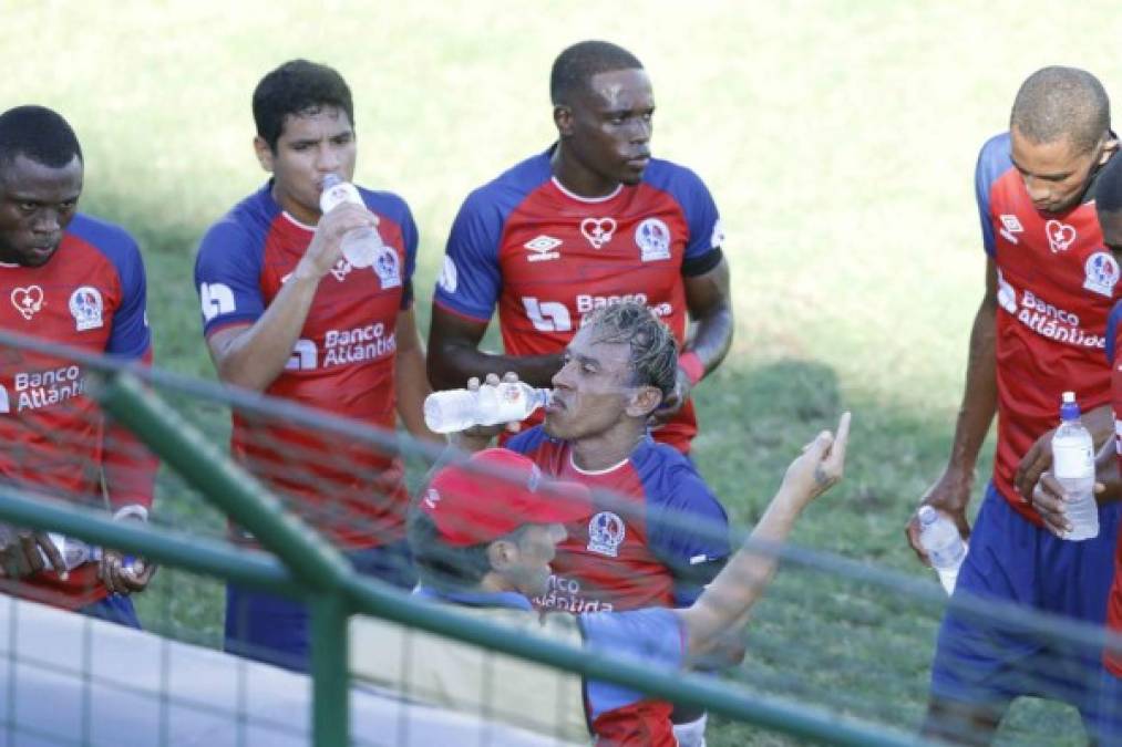 Pedro Troglio dando indicaciones a sus jugadores mientras algunos toman agua, en una pausa del partido.