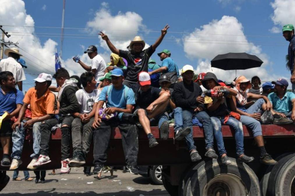 Honduran migrants onboard a truck take part in a caravan heading to the US, in the outskirts of Tapachula, on their way to Huixtla, Chiapas state, Mexico, on October 22, 2018. - President Donald Trump on Monday called the migrant caravan heading toward the US-Mexico border a national emergency, saying he has alerted the US border patrol and military. (Photo by Johan ORDONEZ / AFP)