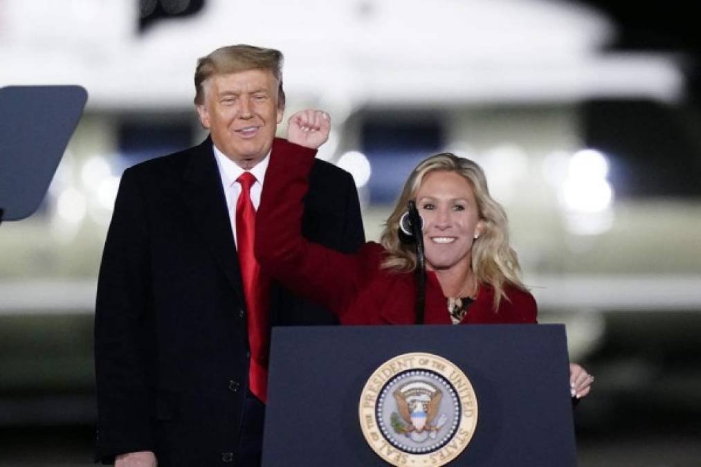 Rep. Marjorie Taylor Greene, R-Ga., speaks as President Donald Trump listens at a campaign rally in support of Senate candidates Sen. Kelly Loeffler, R-Ga., and David Perdue in Dalton, Ga., Monday, Jan. 4, 2021. (AP Photo/Brynn Anderson)