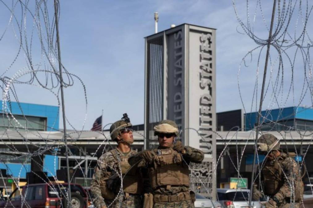 US Department of Defence personnel install barriers requested by Custom and Border Protection at the San Ysidro port of entry, San Diego, US, under the Operation Secure Line anticipating the arrival of Central American migrants heading towards the border, as seen from the Mexican side of the border in Tijuana, Mexico, on November 13, 2018. - US Defence Secretary Jim Mattis said Tuesday he will visit the US-Mexico border, where thousands of active-duty soldiers have been deployed to help border police prepare for the arrival of a 'caravan' of migrants. (Photo by GUILLERMO ARIAS / AFP)