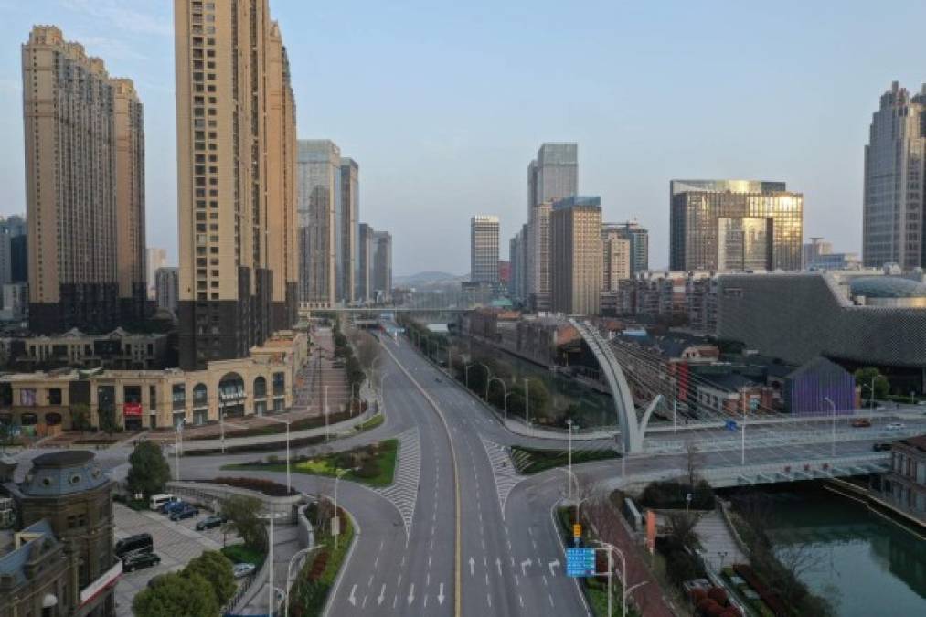 This aerial photo taken on March 10, 2020 shows an empty street in Wuhan in China's central Hubei province. - China said on March 10 the epicentre of the new coronavirus outbreak Hubei would relax travel restrictions to allow healthy people to move within the hard-hit province. (Photo by STR / AFP) / China OUT