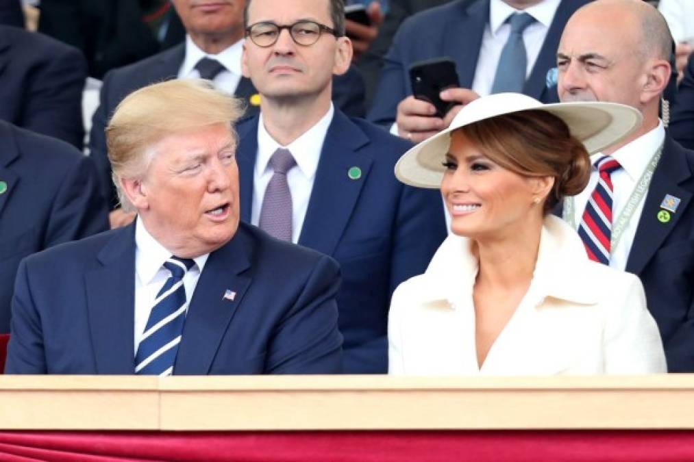US President Donald Trump (L) talks with US First Lady Melania Trump (R) in the royal box during an event to commemorate the 75th anniversary of the D-Day landings, in Portsmouth, southern England, on June 5, 2019. during an event to commemorate the 75th anniversary of the D-Day landings, in Portsmouth, southern England, on June 5, 2019. - US President Donald Trump, Queen Elizabeth II and 300 veterans are to gather on the south coast of England on Wednesday for a poignant ceremony marking the 75th anniversary of D-Day. Other world leaders will join them in Portsmouth for Britain's national event to commemorate the Allied invasion of the Normandy beaches in France -- one of the turning points of World War II. (Photo by Chris Jackson / AFP)