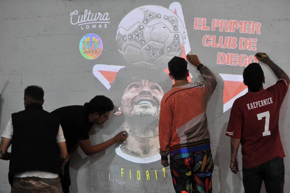 Jóvenes, que no vieron jugar a Maradona, lo idolatran en Argentina. En imagen, los aficionados de Argentinos Juniors, el primer club de Maradona, dibujan su imagen.