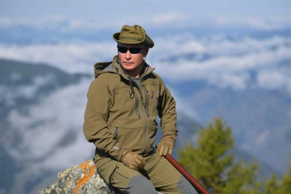 Putin, ataviado con ropa, botas y gorro de camuflaje, aparece haciendo senderismo y posando para los fotógrafos.