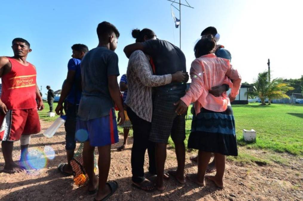 Sobrevivientes del naufragio donde murieron 27 pescadores son abrazados por familiares al llegar a la Base Naval de Caratasca, Puerto Lempira, departamento de Gracias a Dios. AFP