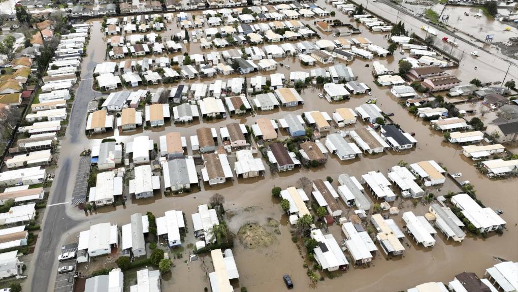 This aerial view shows a flooded neighborhood in Merced, California on January 10, 2023. - A massive storm called a bomb cyclone" by meteorologists has arrived and is expected to cause widespread flooding throughout the state. (Photo by JOSH EDELSON / AFP)