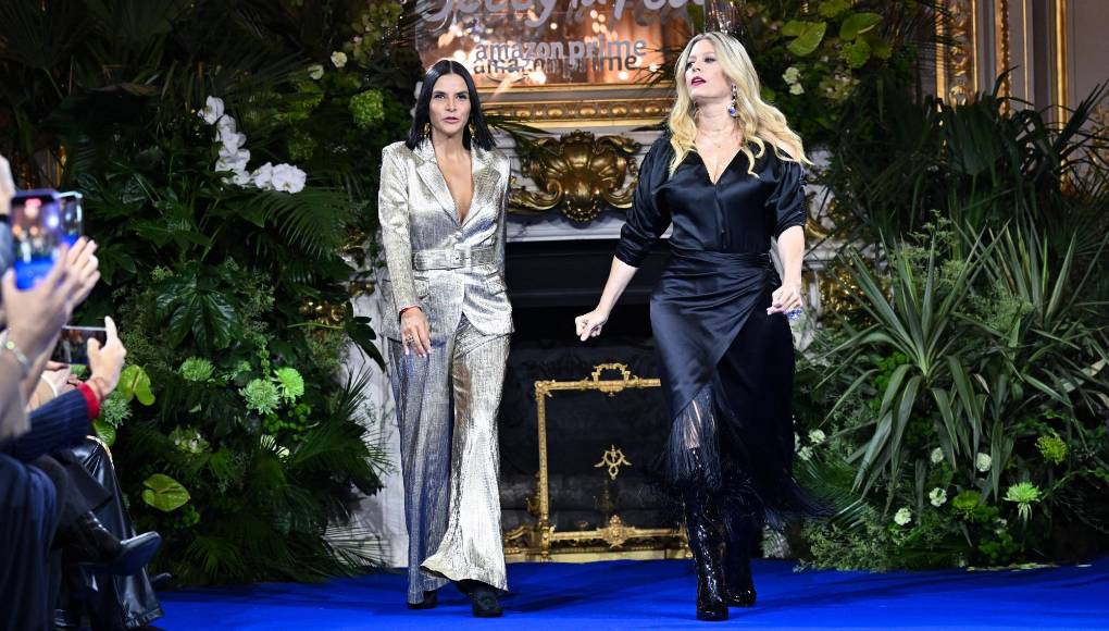 Colombian actress Natalia Ramirez (L) and Lorna Cepeda (R) present creations during a show launching the 'Hugo Lombardi Collection', a main protagonist in the Latin American telenovela 'Ugly Betty' or 'Betty, la fea' an Amazon Prime show, on the sidelines of Paris Fashion Week, at the Shangri-la in Paris on February 27, 2024. The launch of the Hugo Lombardi collection will feature select pieces by the real designer, Andres Otalora, the Colombian ready-to-wear designer, who has specialized for more than two decades in creating designs on the international scene and in the fashion weeks in New York and Paris. (Photo by Miguel MEDINA / AFP)