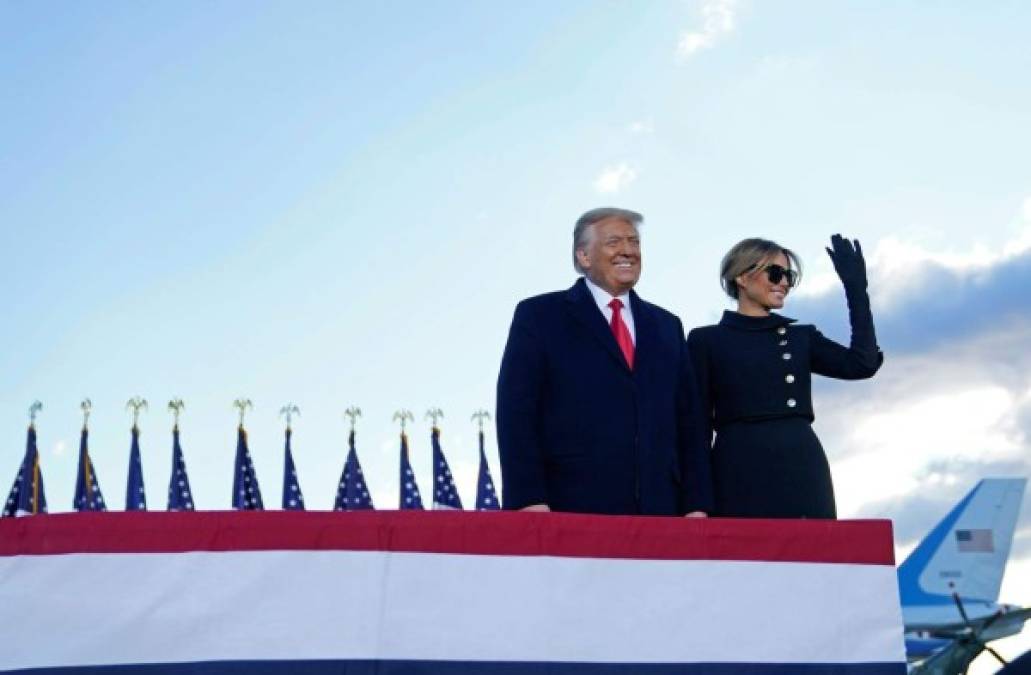 Outgoing US President Donald Trump and First Lady Melania Trump address guests at Joint Base Andrews in Maryland on January 20, 2021. - President Trump and the First Lady travel to their Mar-a-Lago golf club residence in Palm Beach, Florida, and will not attend the inauguration for President-elect Joe Biden. (Photo by ALEX EDELMAN / AFP)