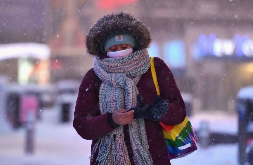 "A woman walks through the snow in Times Square during a winter storm on February 1, 2021 in New York City. - A powerful winter storm is set to dump feet of snow along a stretch of the US east coast including New York City on February 1, 2021, after blanketing the nation's capital. The National Weather Service issued storm warnings from Virginia to Maine -- a swathe home to tens of millions of people -- and forecast snowfall of 18 to 24 inches (45-60 centimeters) in southern New York, northeastern New Jersey and parts of southwest Connecticut. (Photo by Angela Weiss / AFP)"