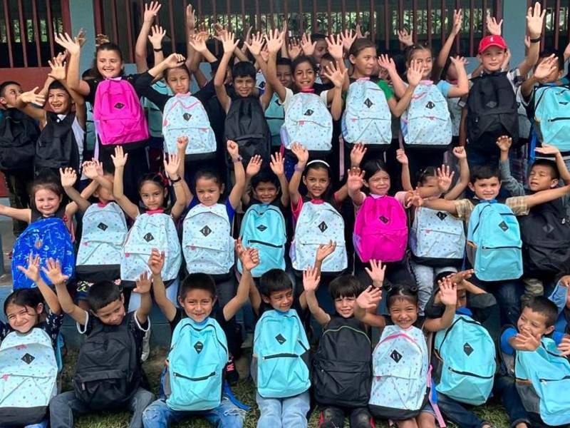 Los niños muestran alegría al recibir útiles escolares.