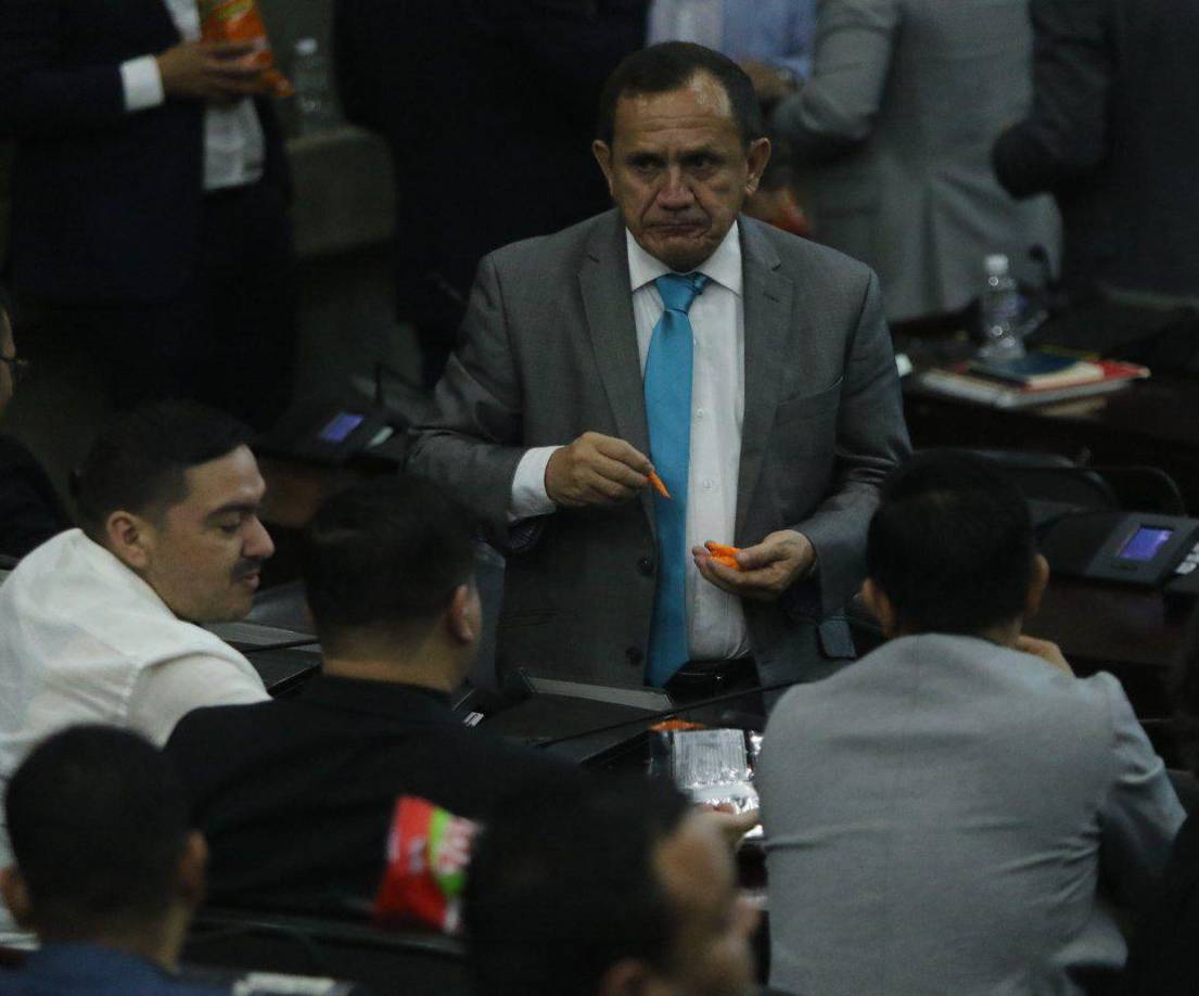 El diputado Samuel Madrid habla con sus colegas de Libre sobre la elección de la nueva Corte Suprema de Justicia.