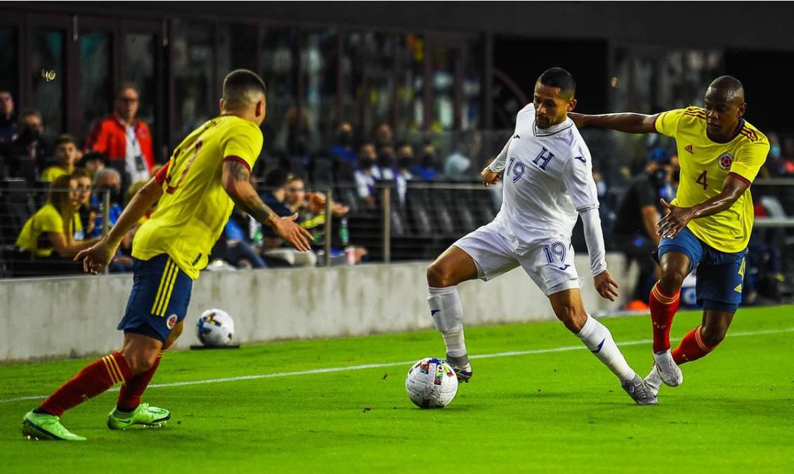 Omar Elvir conduciendo el balón entre Yerson Candelo y Juan Fernando Quintero.