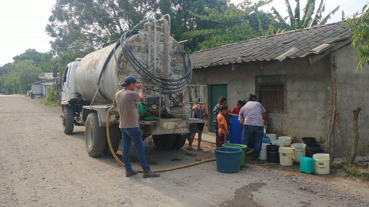 Una camión proporciona agua a las viviendas.