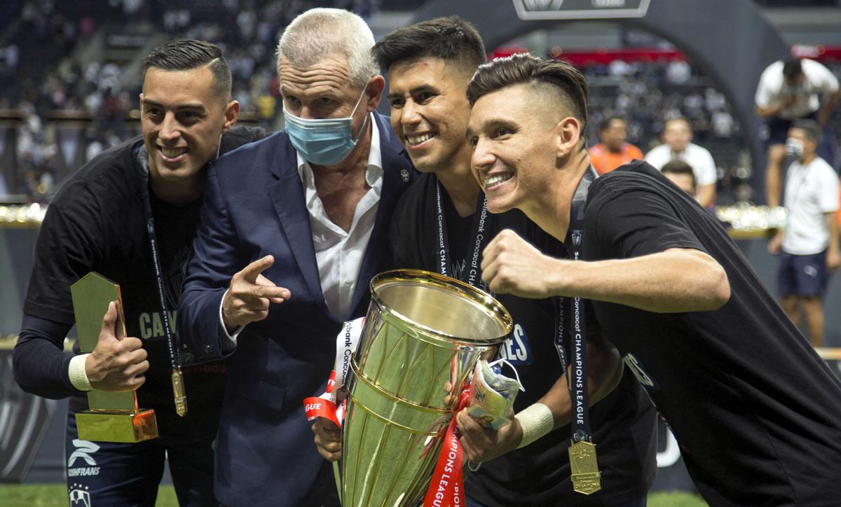 Javier Aguirre posando con sus jugadores y el trofeo de la Concachampions.