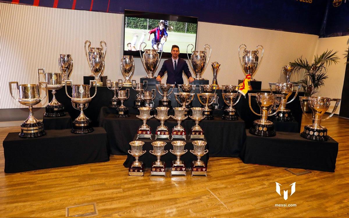 Leo Messi posando con todos sus trofeos que ganó con el FC Barcelona.