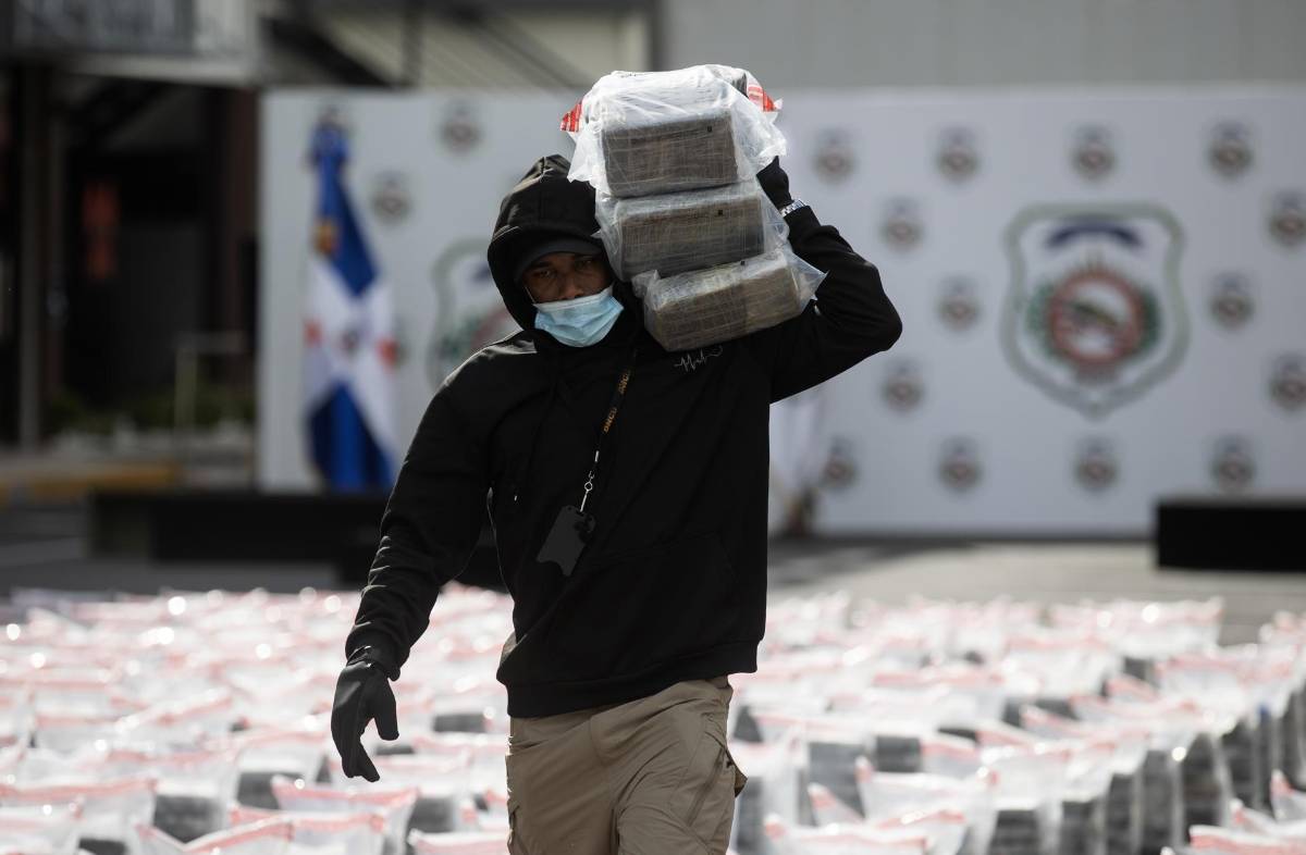 Un agente de la Dirección Nacional de Control de Drogas (DNCD), sostiene bolsas incautadas el viernes, en Santo Domingo.