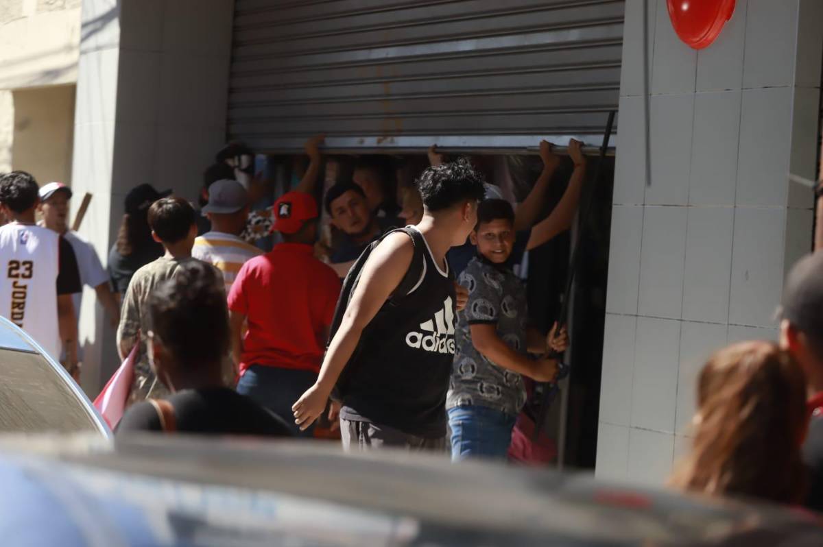 Un grupo de manifestantes intenta cerrar un comercio del centro de la ciudad.