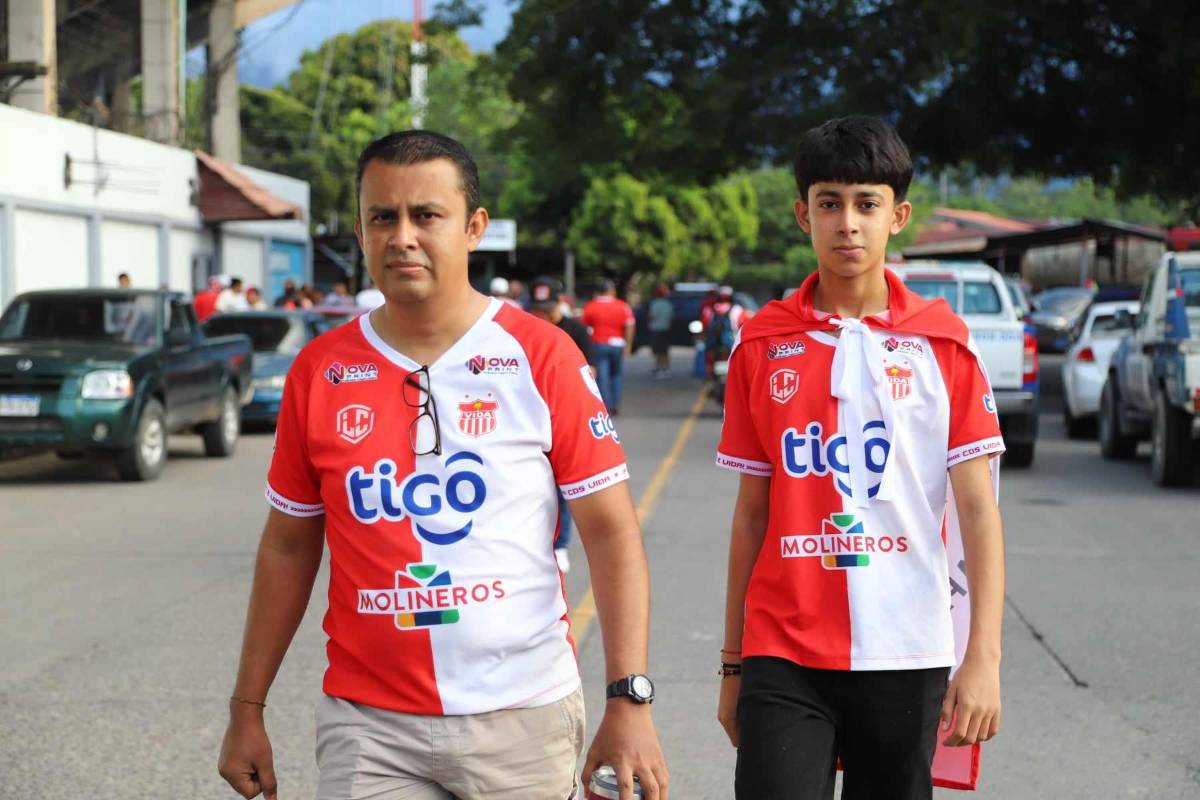 Dos aficionados del Vida llegando al estadio Municipal Ceibeño.