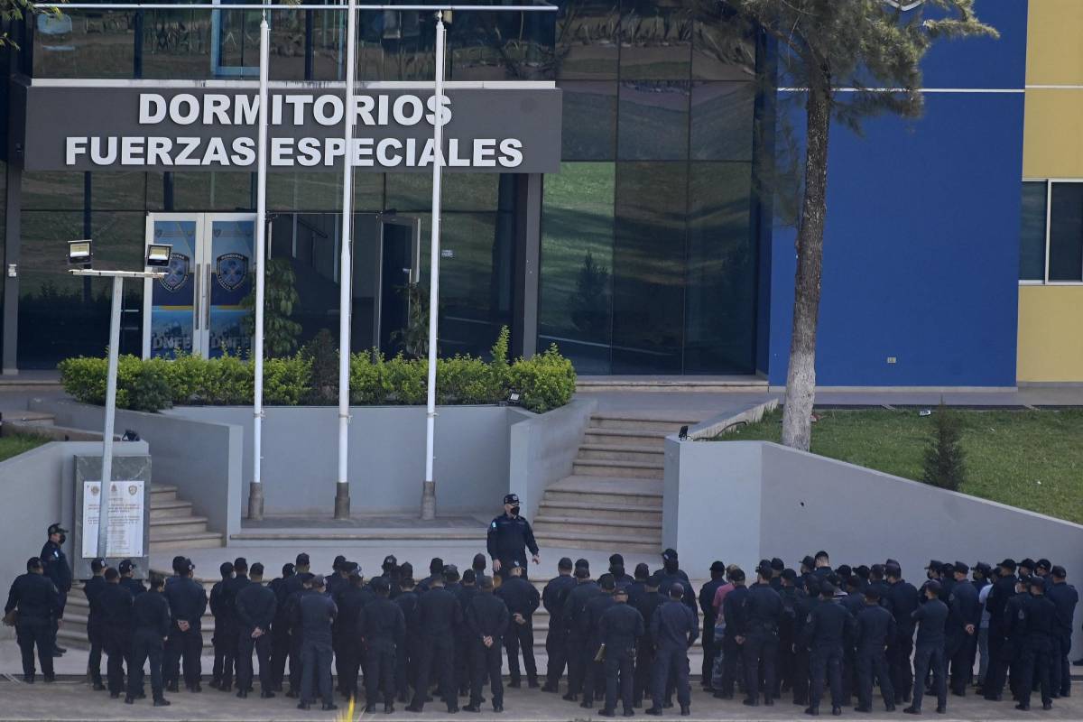 Miembros de la Dirección de Fuerzas Especiales se reúnen con sus superiores en las afueras del predio donde se encuentra detenido el expresidente Juan Orlando Hernández en espera de su extradición a Estados Unidos, en Tegucigalpa el 30 de marzo de 2022.
