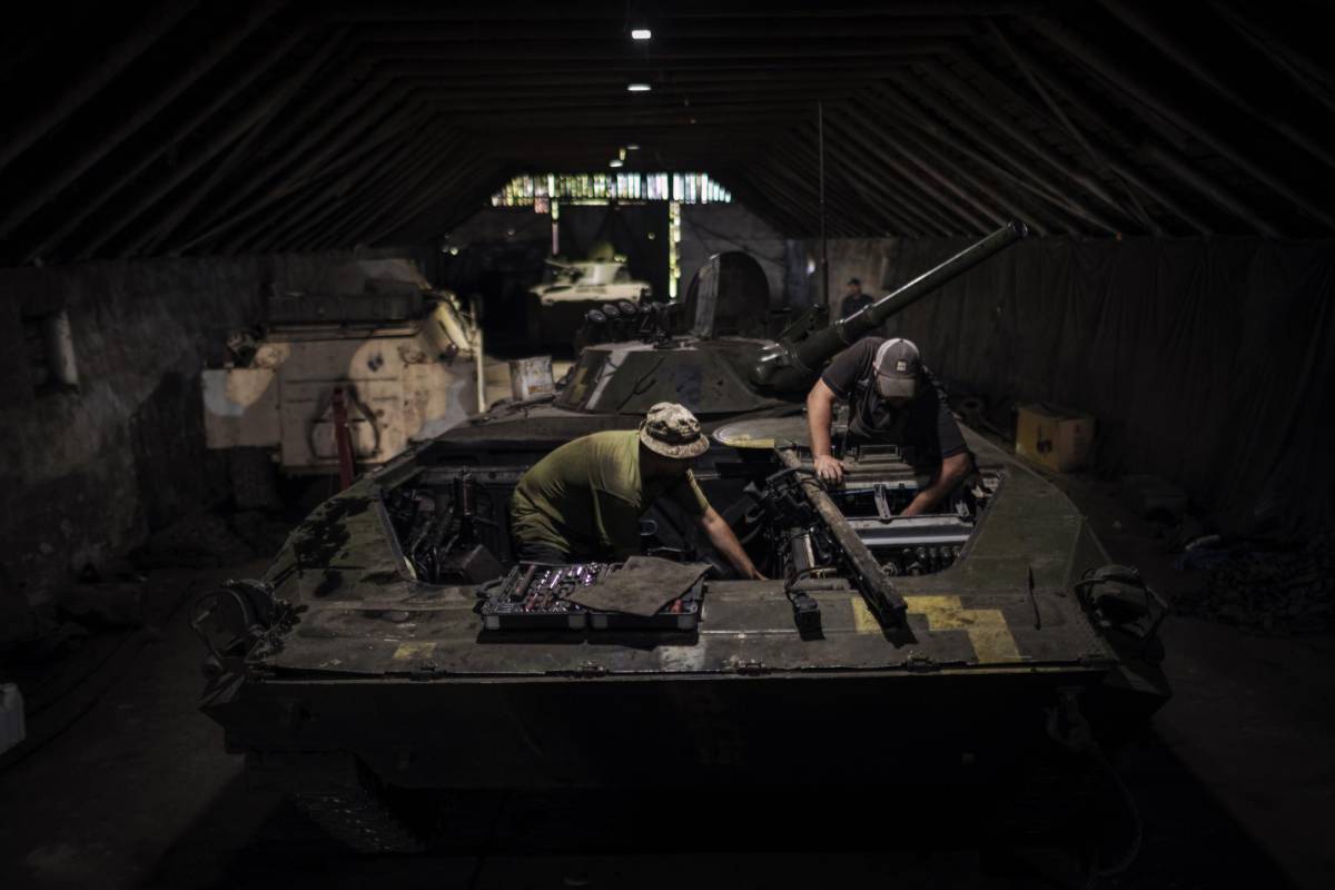 Miembros de la 35.a Brigada de Infantería de Marina reparan un vehículo de combate de infantería de la era soviética, en la región de Donetsk, en el sur de Ucrania, el 29 de julio de 2023.