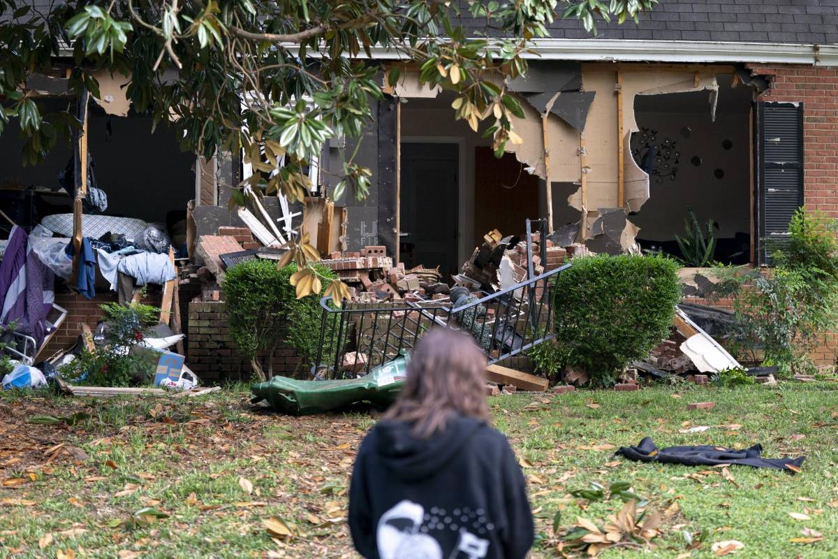 Una mujer observa la escena donde cuatro policías fueron abatidos al intentar detener a un fugitivo.