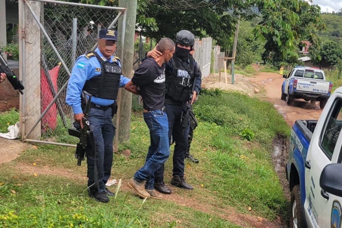 El sospechoso es resguardado por agentes de la Policía tras su captura.