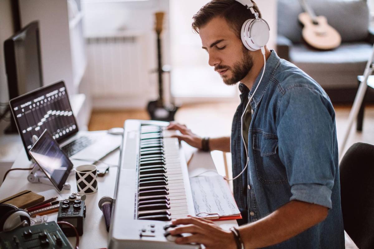 Inspired Young Artist Playing Electric Piano In His Comfortable Home