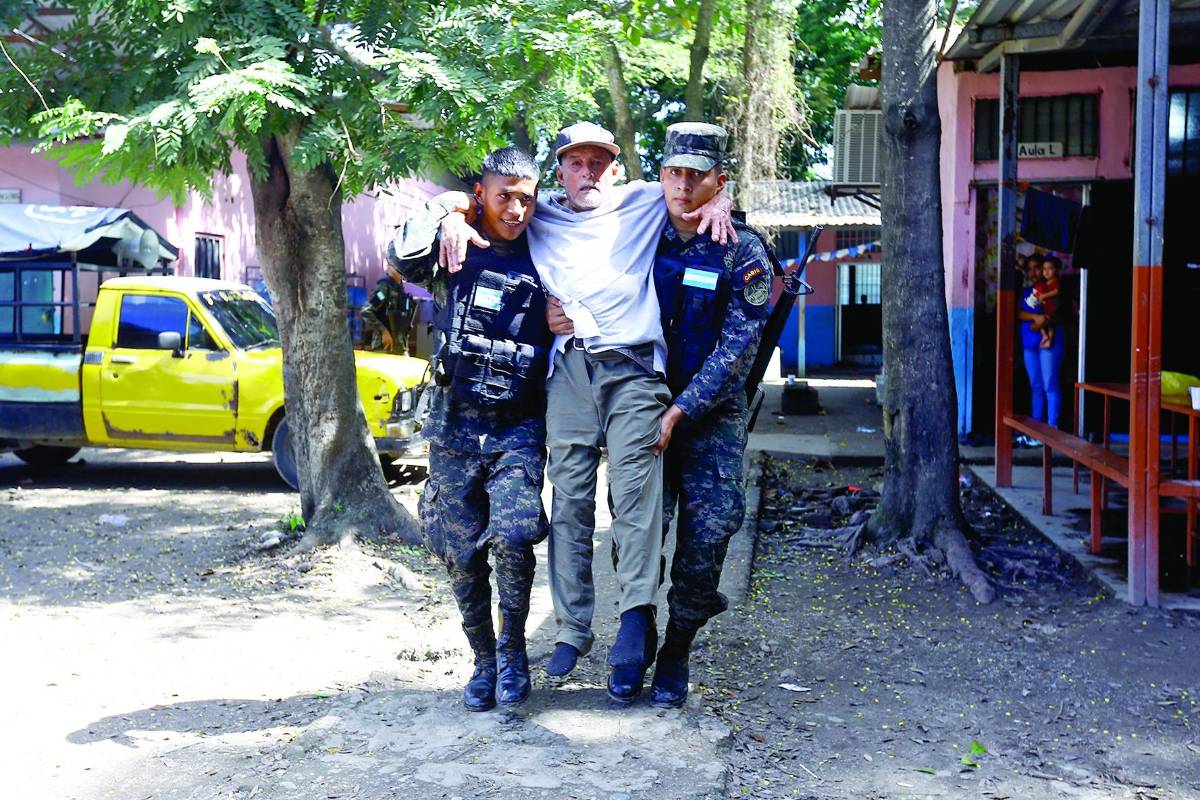 Militares ayudan a una persona de la tercera edad.