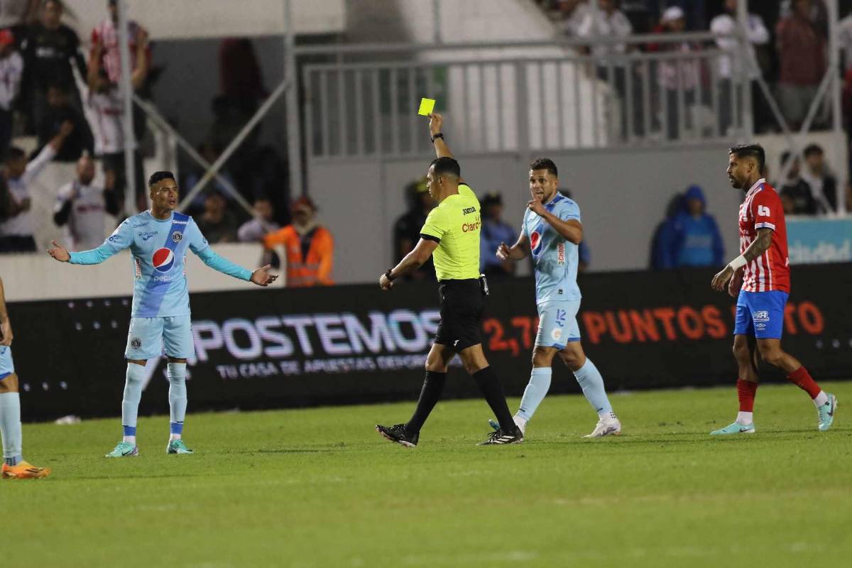 Momento donde el árbitro Nelson Salgado le muestra la tarjeta amarilla a Juan Delgado.