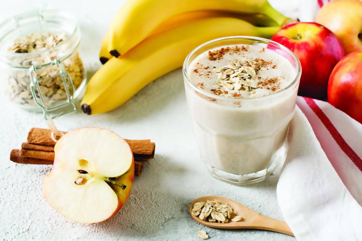 Apple and banana oatmeal smoothie raw helthy breakfast over background whit