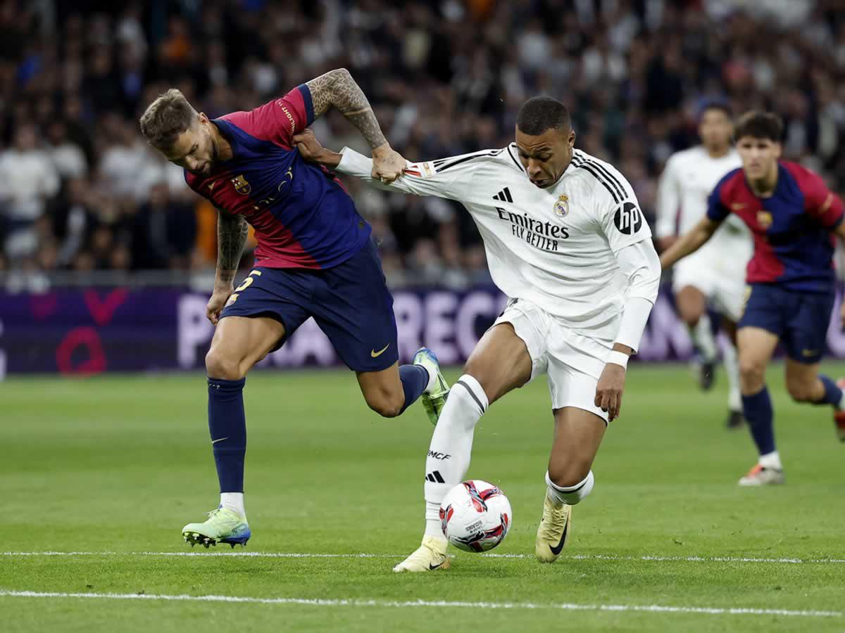Kylian Mbappé trata de escaparse de Iñigo Martínez en el Clásico.