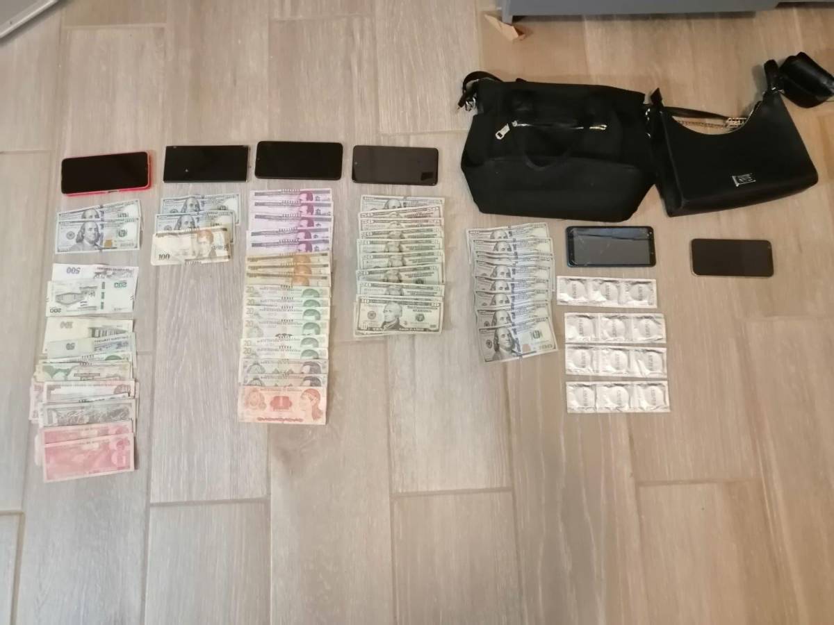 Dinero, celulares y preservativos decomisados por la Policía.