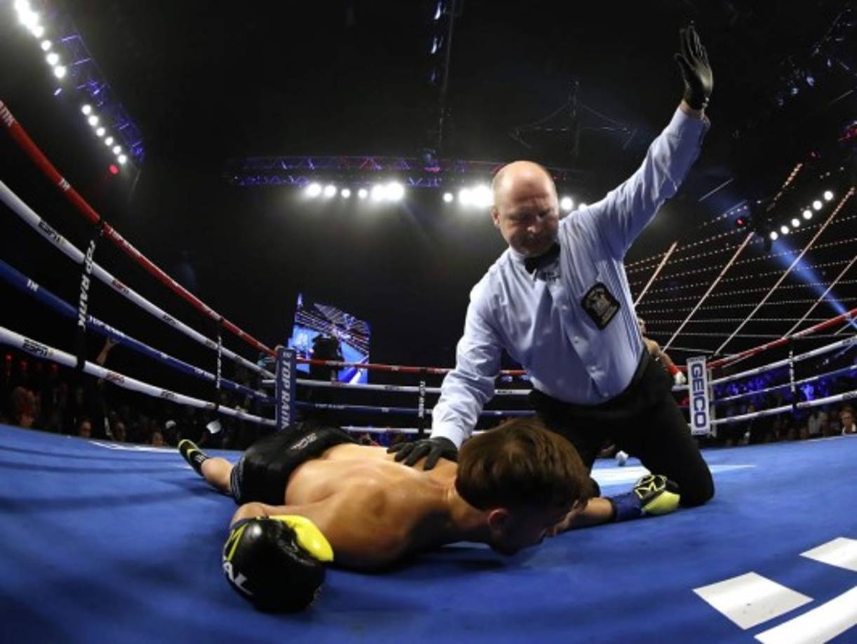 Mason Menard es atendido por el árbitro tras el derechazo que le dio Teófimo López.