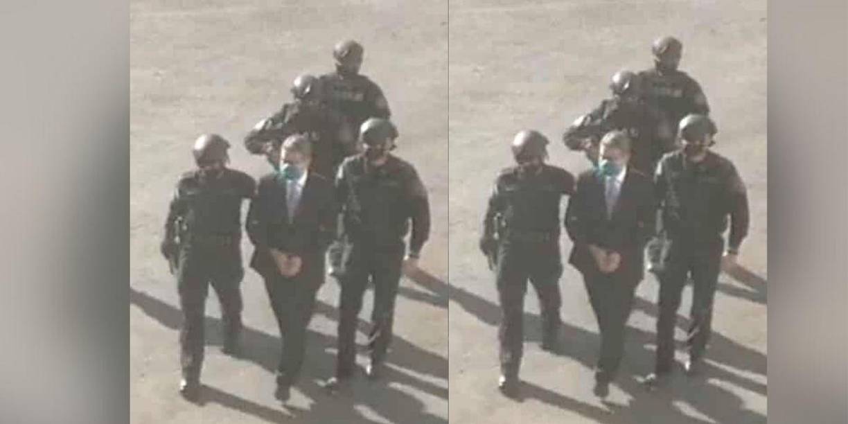 Hernández lució un traje oscuro y fue esposado de manos. El protocolo incluyó a decenas de elementos de seguridad de distintas instituciones estatales. 