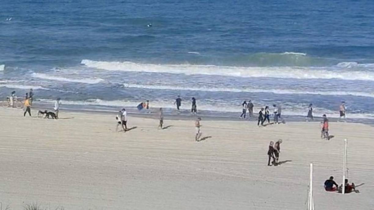 JACKSONVILLE BEACH, FLORIDA - APRIL 17: People are seen at the beach on April 17, 2020 in Jacksonville Beach, Florida. Jacksonville Mayor Lenny Curry announced Thursday that Duval County's beaches would open at 5 p.m. but only for restricted hours and can only be used for swimming, running, surfing, walking, biking, fishing, and taking care of pets. Sam Greenwood/Getty Images/AFP