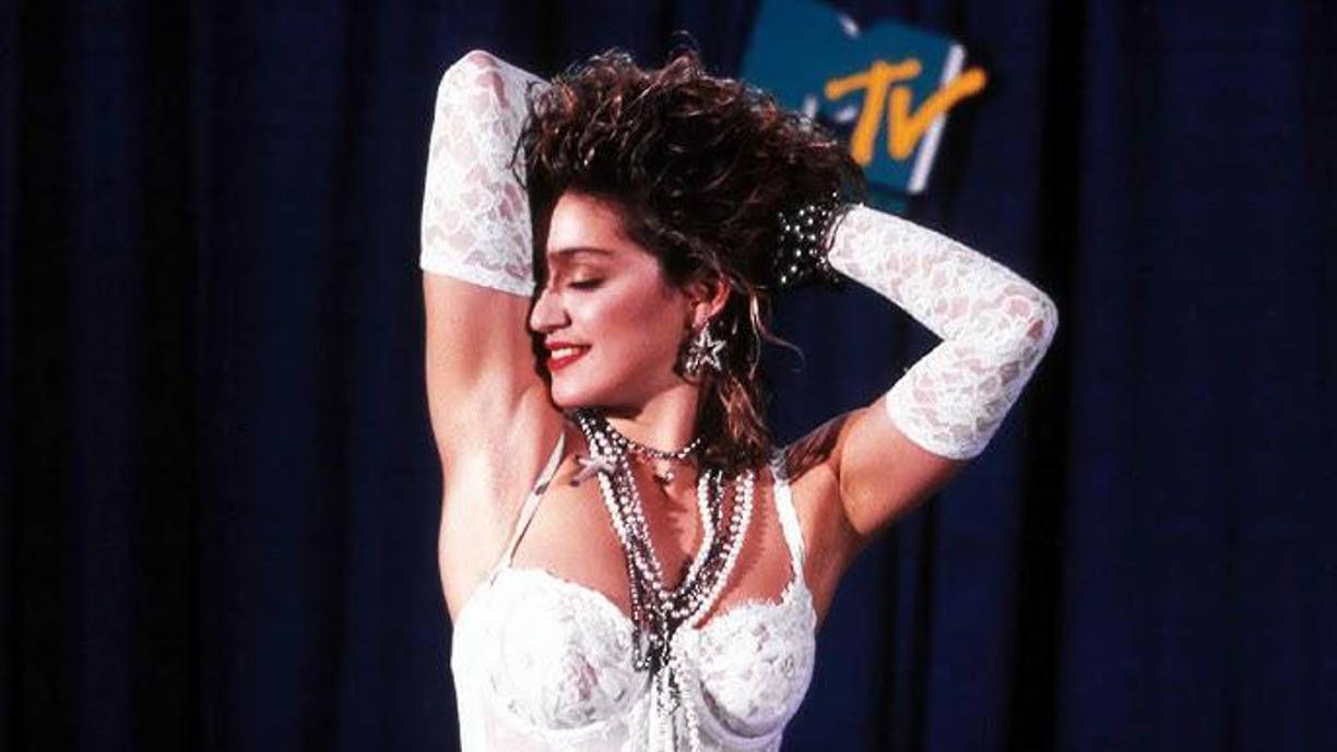 Por primera vez un canal hablaba a los jóvenes en sus propios códigos y motivaba a esos jóvenes a aprender nuevos códigos a través de sus emisiones.Más que una actuación.Ataviada con un vestido de novia, un cinturón con las palabras ‘Boy Toy’ y la cabeza cubierta por un velo, Madonna salía de una tarta gigante al comienzo de la actuación para, después cantar su icónico tema con miradas a la cámara, sabiéndose dueña de su actuación y del relato que desprendía. En un alarde de improvisación para buscar un tacón perdido, como declararía la cantante años más tarde, Madonna se tiró al suelo en los tramos finales de la canción, arrastrándose y simulando que se masturbaba. La escena, apenas treinta segundos de los casi cuatro minutos totales, quedó para el recuerdo por su mensaje transgresor y despertó la ira de las mentes más conservadoras de la época.