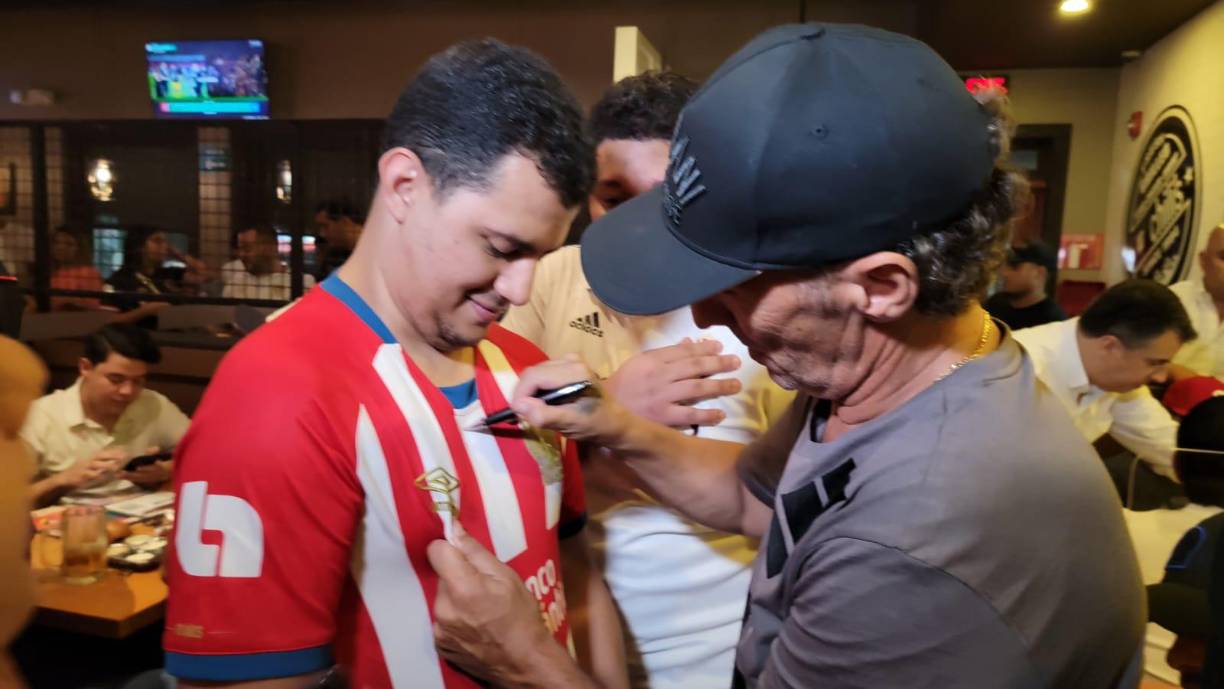 Pedro Troglio en el momento que le firmaba la camiseta a un aficionado.