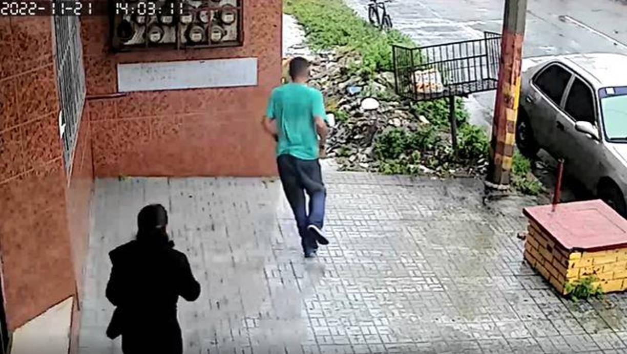 Él vestía una camiseta verde, pantalones azules y tenis.