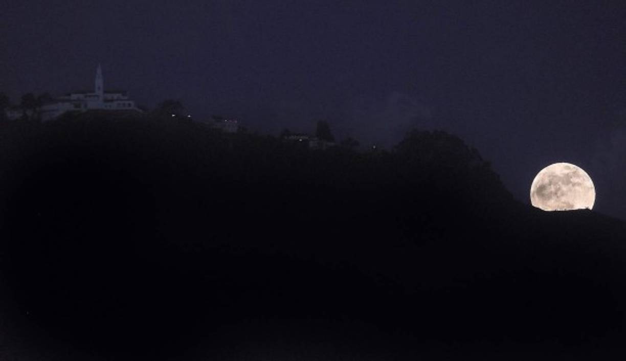 La luna despunta sobre las montañas que rodean a Bogotá, Colombia.