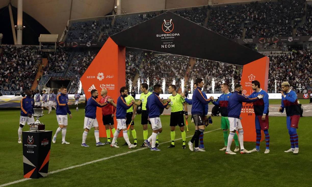 Los jugadores del Real Madrid y del Barcelona se saludan antes antes del inicio del partido.