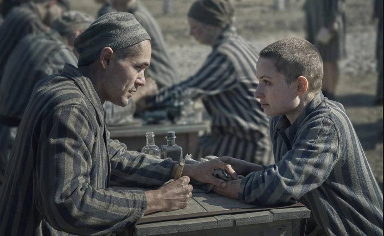 <b>‘EL TATUADOR DE AUSCHWITZ’ (Peacock y Movistar Plus+) </b>La miniserie de seis episodios adapta el ‘best-seller’ de Heather Morris, inspirada en la historia real del prisionero judío Lali Sokolov, encargado de tatuar números de identificación en los brazos de los prisioneros de Auschwitz.Protagonizada por Harvey Keitel, Jonah Hauer-King y Anna Próchniak, cuenta con una banda sonora especial que incluye la canción, ‘Love will survive’, compuesta por el ganador de varios Óscar Hans Zimmer -judío alemán-, e interpretada por Barbra Streisand, que canta por primera vez para una serie.