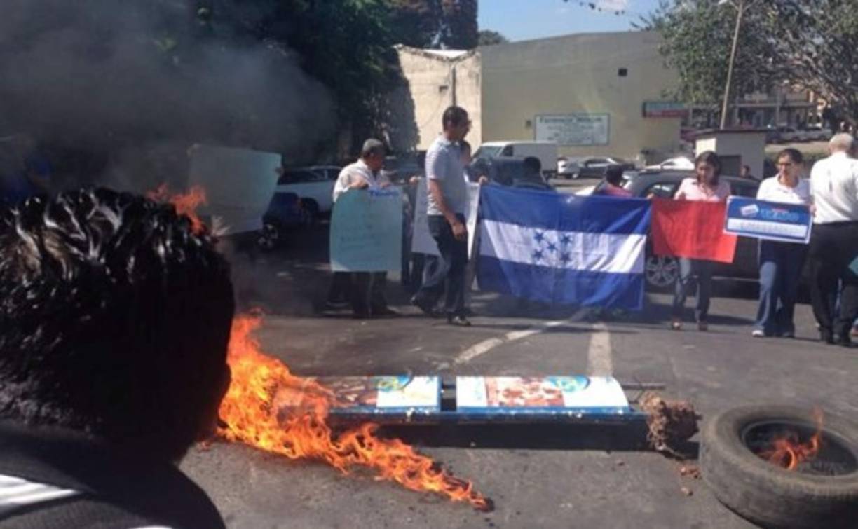 Los trabajadores de diario Tiempo de Honduras quemaron llantas durante una protesta en Tegucigalpa. Foto tomada de ‏@americahn