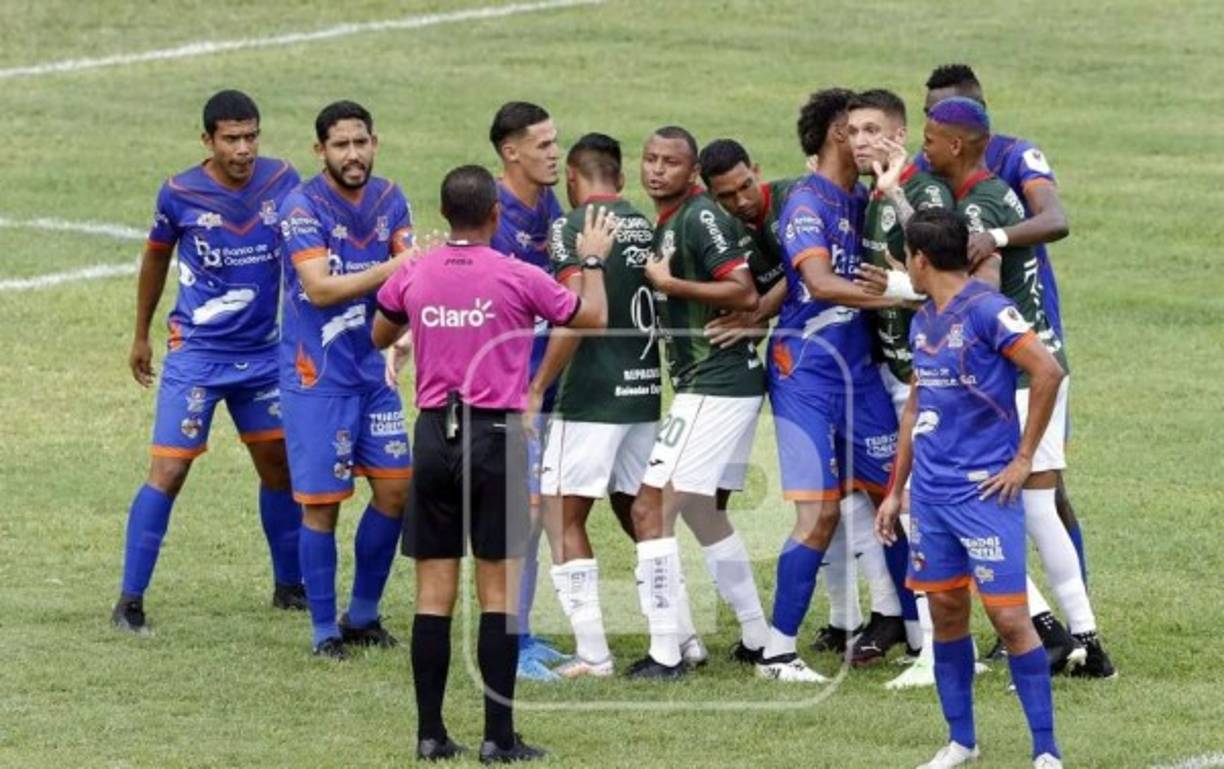 El árbitro Melvin Matamoros pidiendo calma a los jugadores de Marathón y UPN antes de un tiro libre.