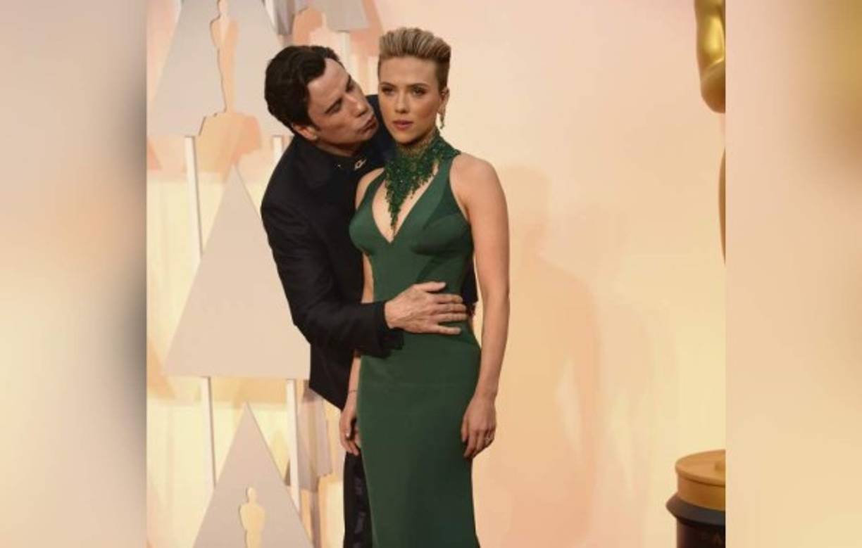 El actor John Travolta quiso sorprender a Scarlett Johansson al darle un beso en la mejilla pero esto ha causado risas.