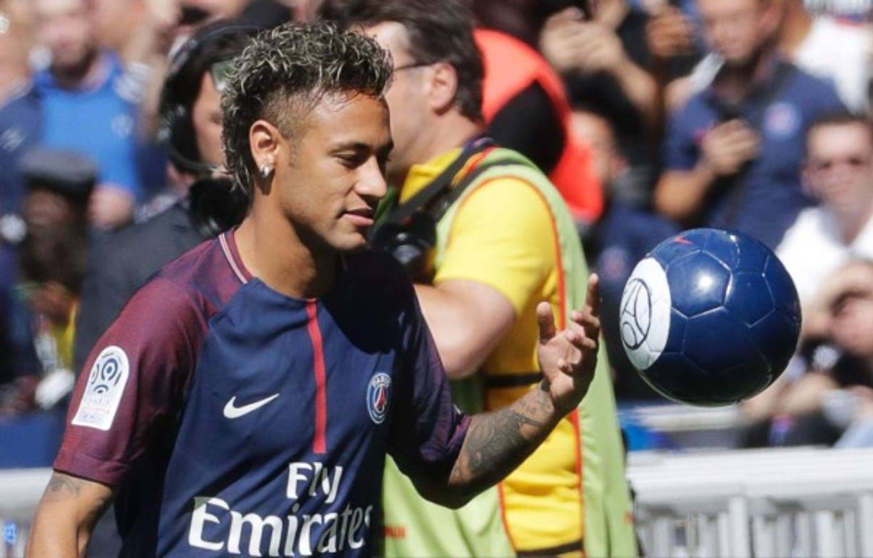 Paris Saint-Germain's Brazilian forward Neymar plays with a ball during his presentation to the fans at the Parc des Princes stadium in Paris, on August 5, 2017.<br/>Brazil superstar Neymar will watch from the stands as Paris Saint-Germain open their season on August 5, 2017, but the French club have already clawed back around a million euros on their world record investment. Neymar, who signed from Barcelona for a mind-boggling 222 million euros ($264 million), is presented to the PSG support prior to his new team's first game of the Ligue 1 campaign against promoted Amiens.<br/> / AFP PHOTO / Thomas Samson
