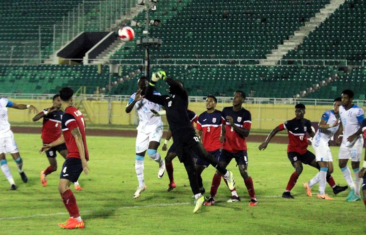El portero cubano Raiko Arozarena sale a despejar el balón ante la marca de Alberth Elis.
